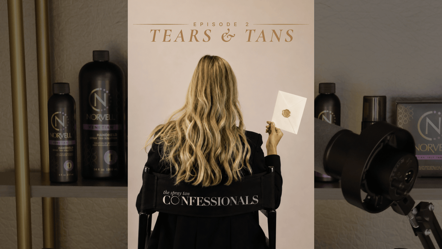 A promotional scene for 'The Spray Tan Confessionals Episode 2: Tears & Tans' featuring a woman with long blonde hair who sits facing away from the camera in a black directors chair, holding an envelope with a gold wax seal against a beige backdrop.