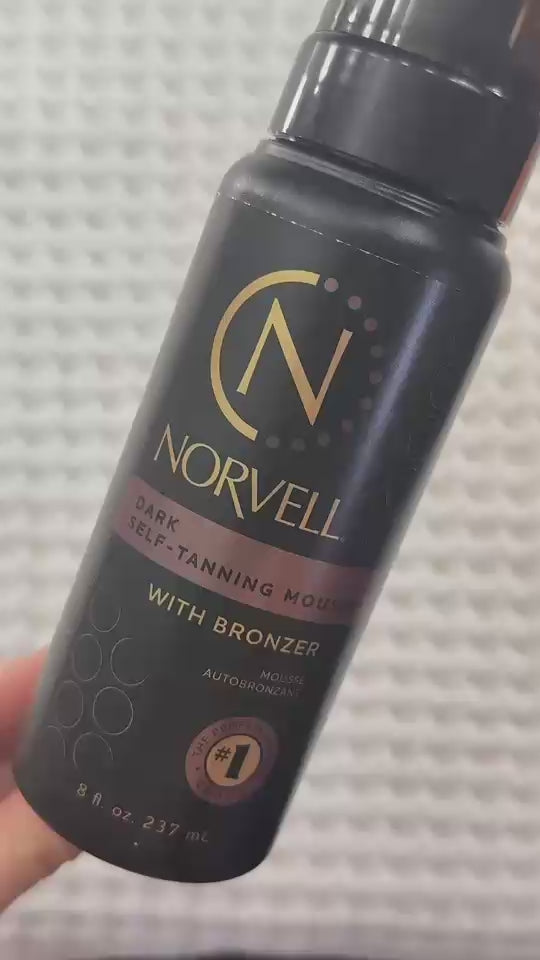 Load video: Dark self tanning Mousse application with Norvell Mitt