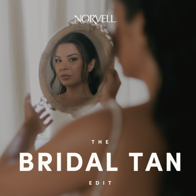 Bride looking in a mirror at her Norvell bridal tan with overlay text in white "The Bridal Tan Edit" and Norvell Logo