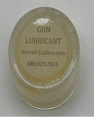 Jar of gun lubricant with label on a gray background