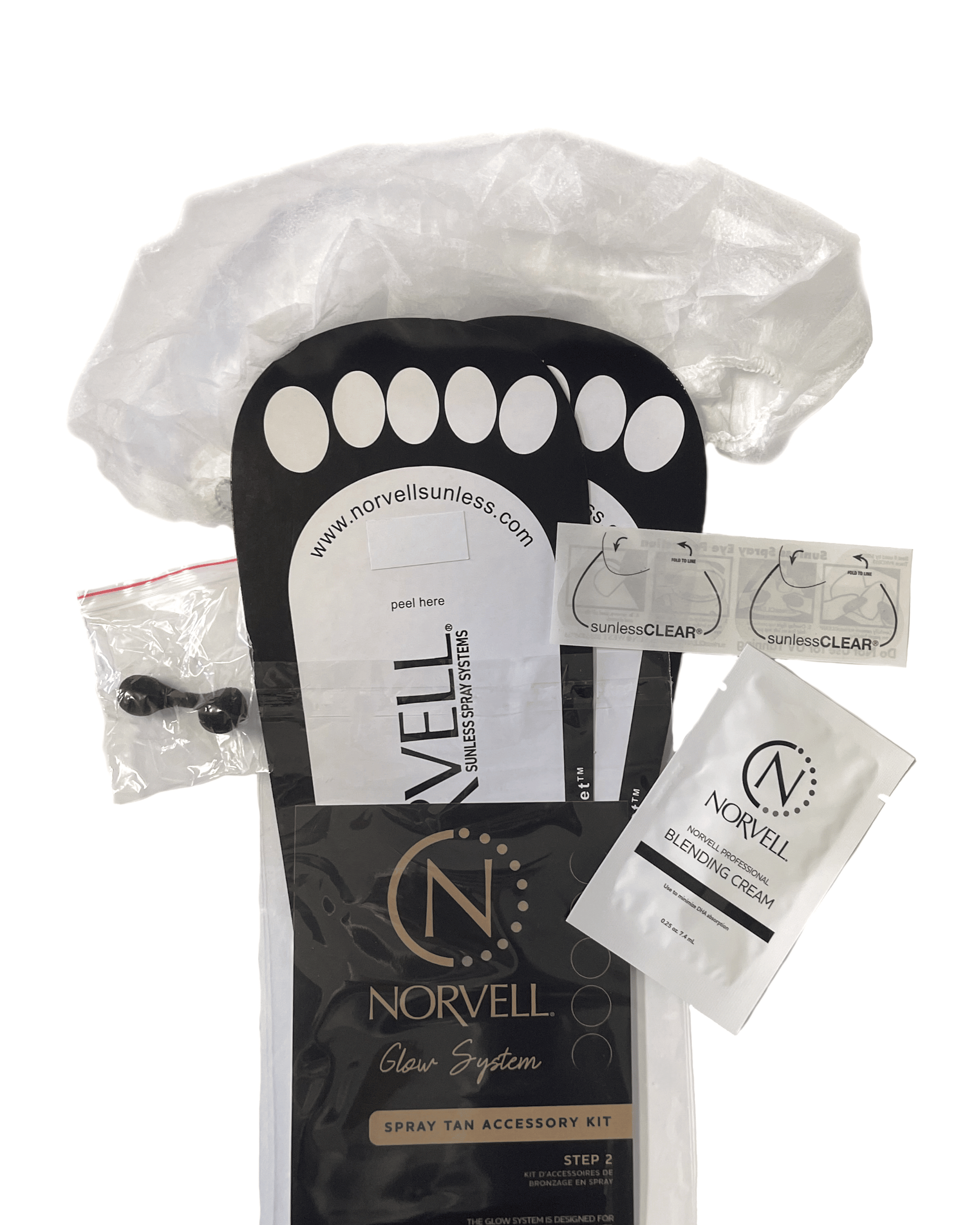 Norvell spray tan accessory kit with applicator and cream on a white background