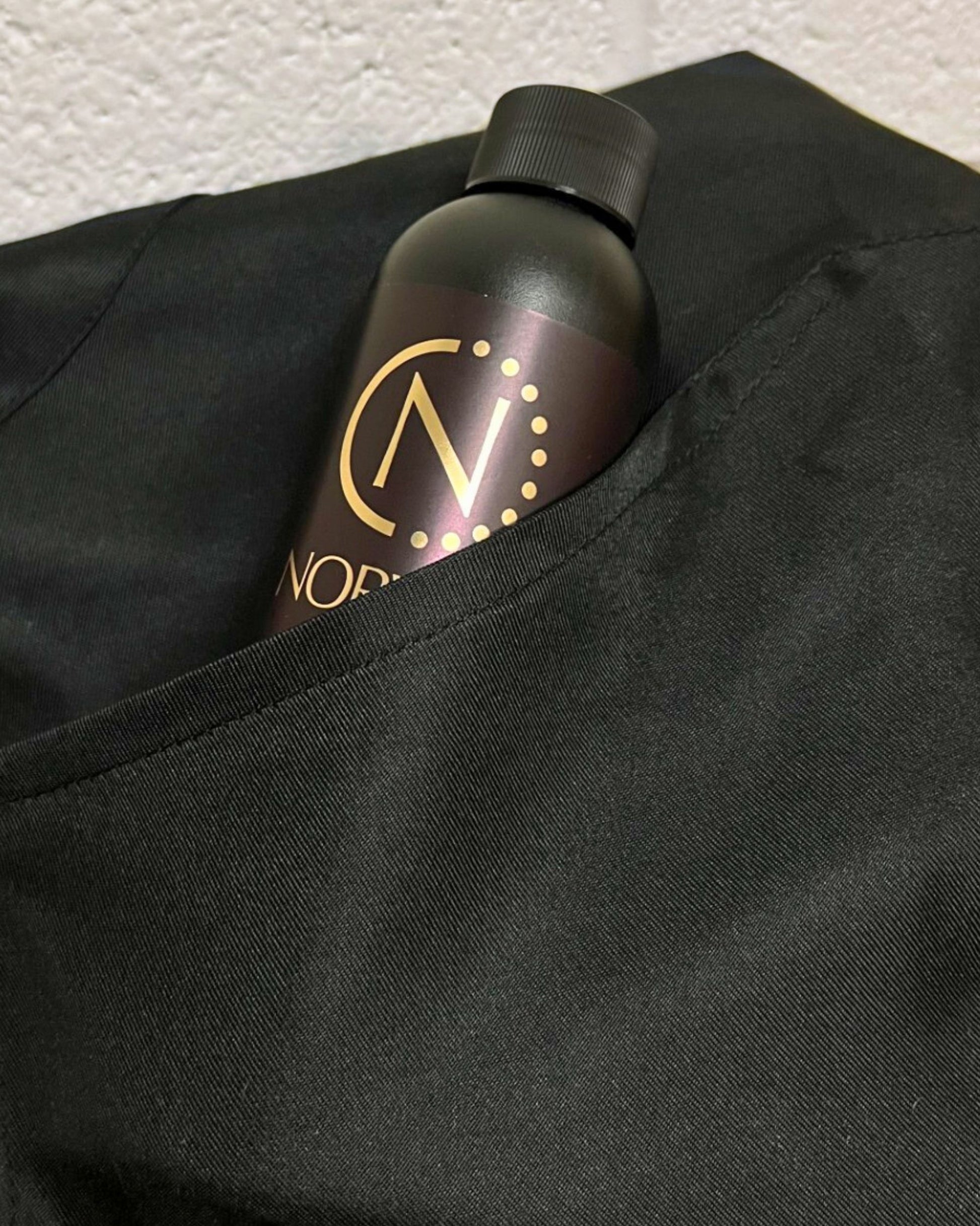 Norvell solution bottle in the Black apron pocket.