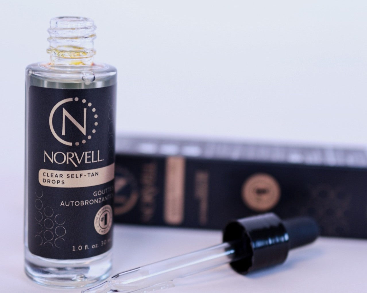 Load video: video showing the clear tanning drops in a lotion