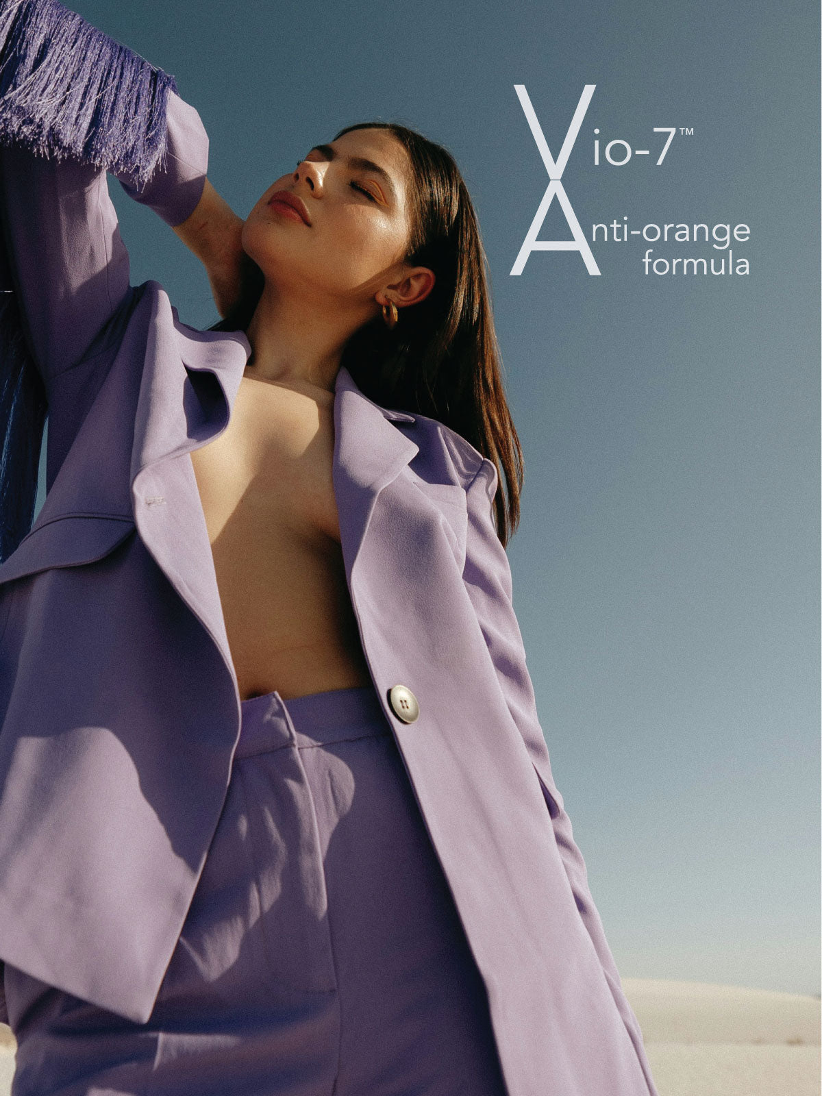 White text Vio-7 Anti-Orange formula floats above Model wearing light purple jacket and slacks.