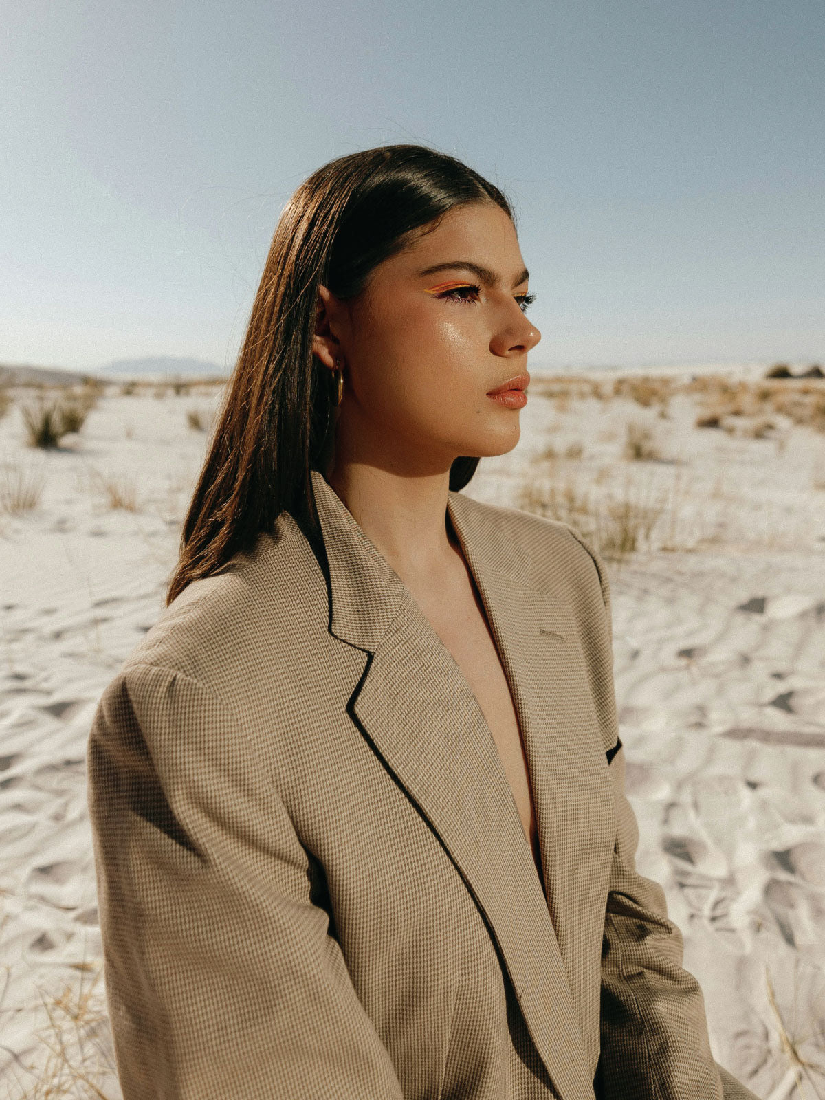 Model in desert wearing oversized tan suit jacket