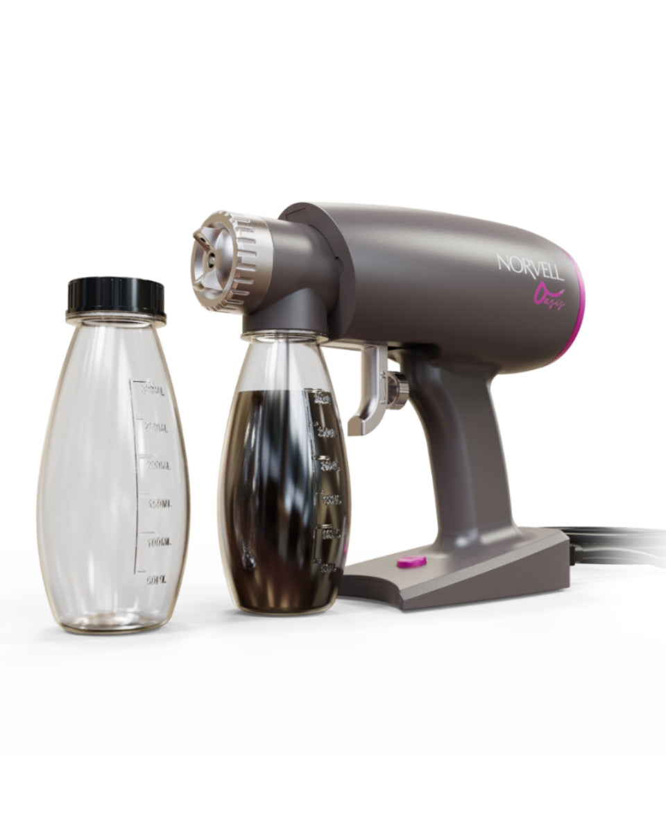Norvell Oasis Gray spray gun with pink accents and 2 clear solution bottles, 1 is filled with solution on a white background