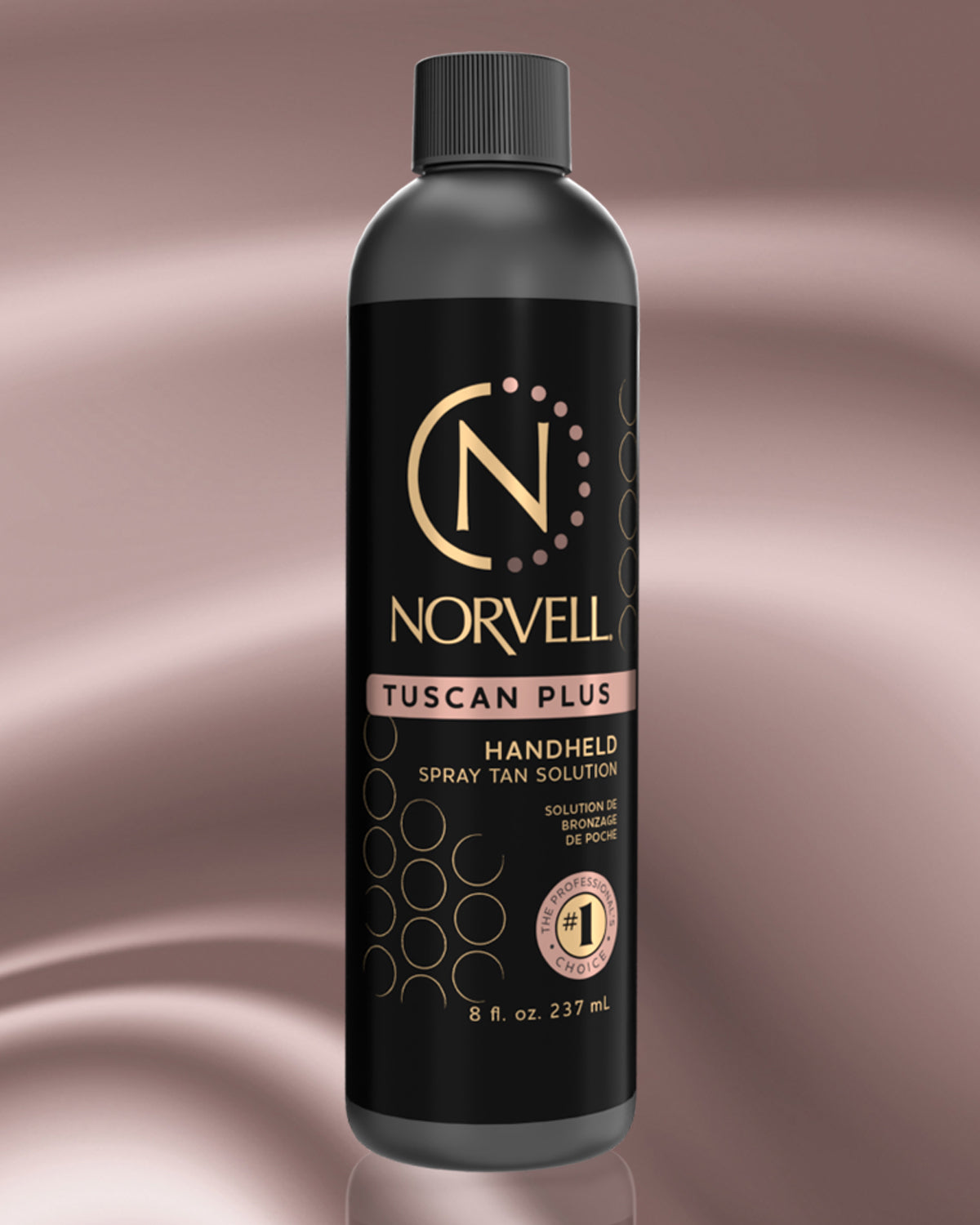 Norvell Tuscan Plus handheld spray tan solution bottle on a rose gold background
