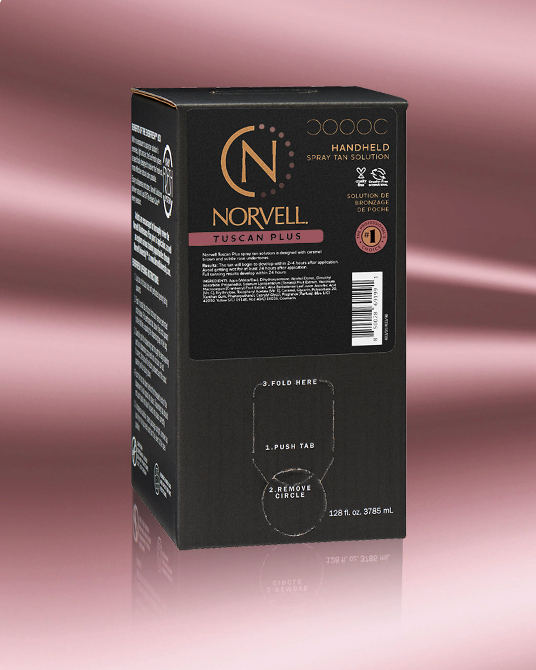 A black Norvell Handheld Spray Tan Solution box for Tuscan Plus, shown on a rose gold gradient background with a reflection below.