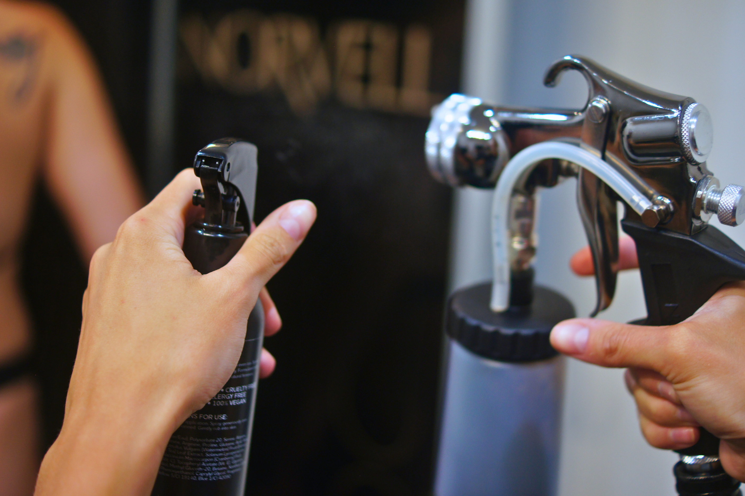 Spray tan artist  hands holding Z300 spray tan gun