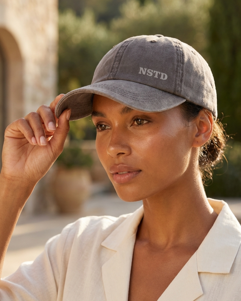 AI Render Woman wearing a gray cap with 'NSTD' logo outdoors